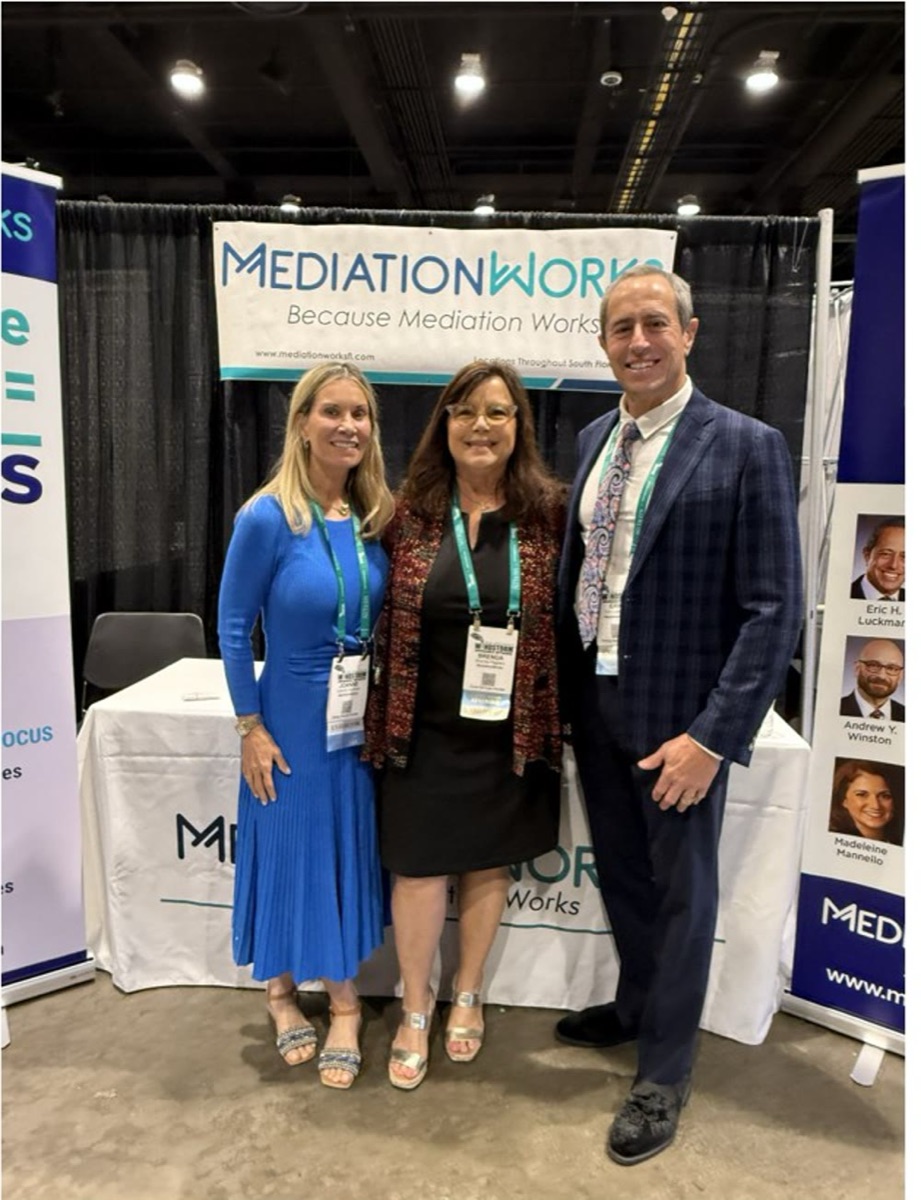 Joanne Luckman, Brenda Pagliaro, and Eric Luckman at the MediationWorks booth, WIND Conference 2026